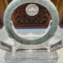Translucent gray-green jade bracelet display