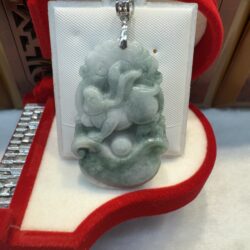 Jade pendant with intricate carved design.