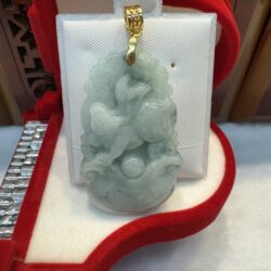 Jade pendant in red velvet jewelry box.