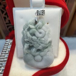 Jade pendant with intricate carving display.