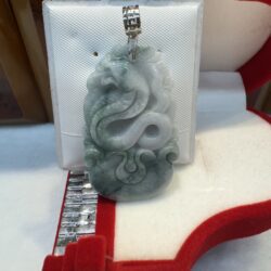 Jade pendant with intricate dragon carving.