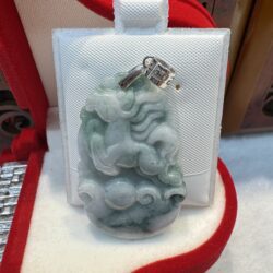 Jade pendant with intricate horse carving.