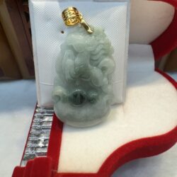 Jade pendant in a red jewelry box.