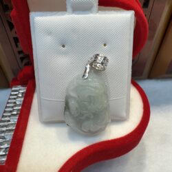 Jade pendant in red velvet jewelry box.
