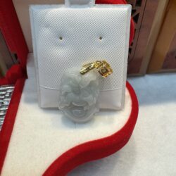 Jade pendant with gold detail in box.