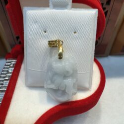 Jade pendant with gold accent in box.