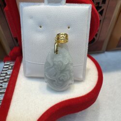 Jade pendant with gold bail in box.