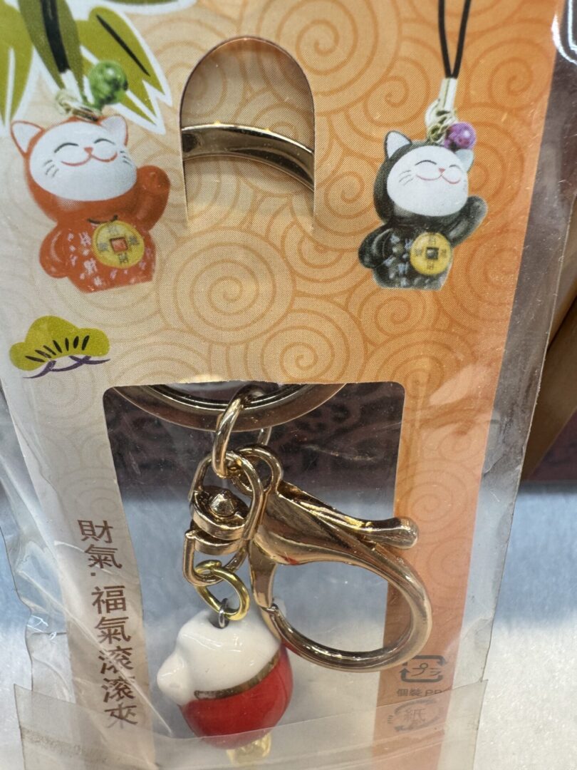 Lucky cat keychain with packaging design.