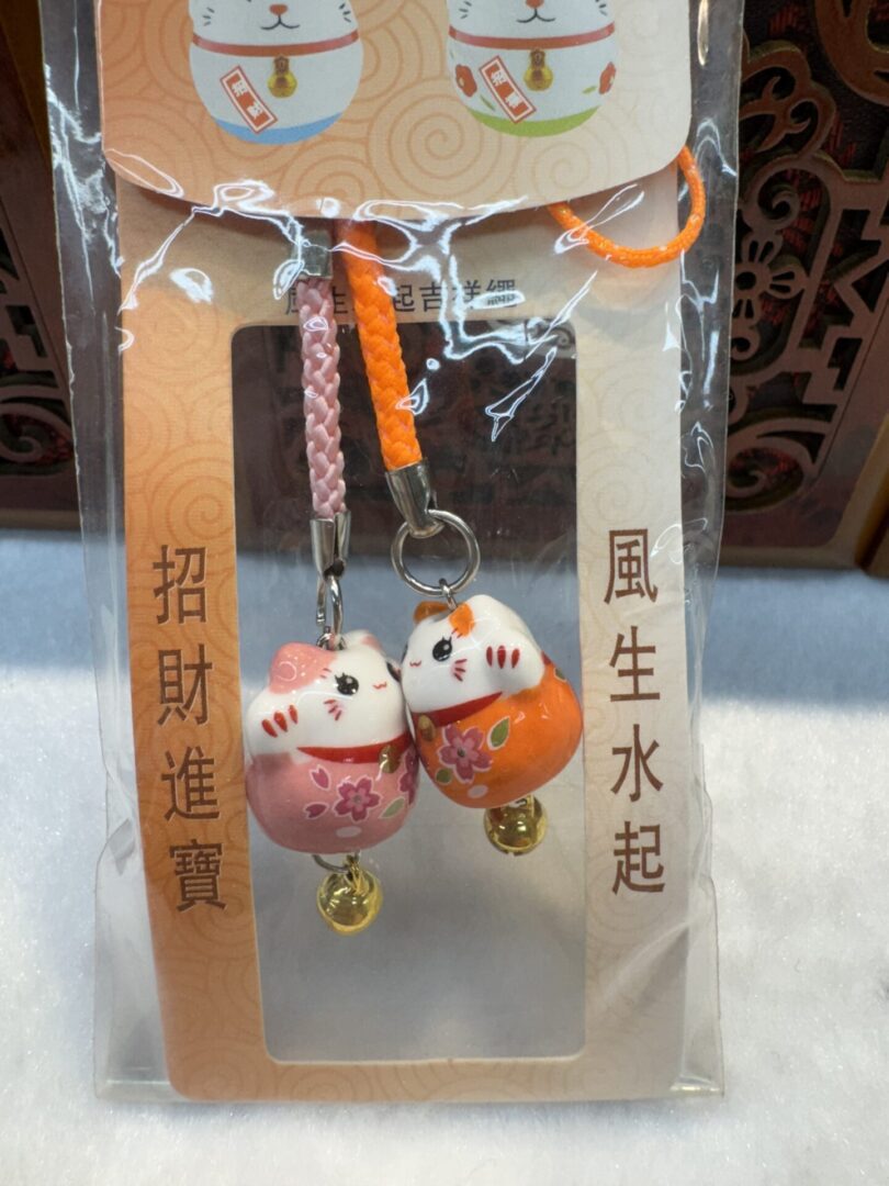 Lucky cat charms in packaged hanging set.