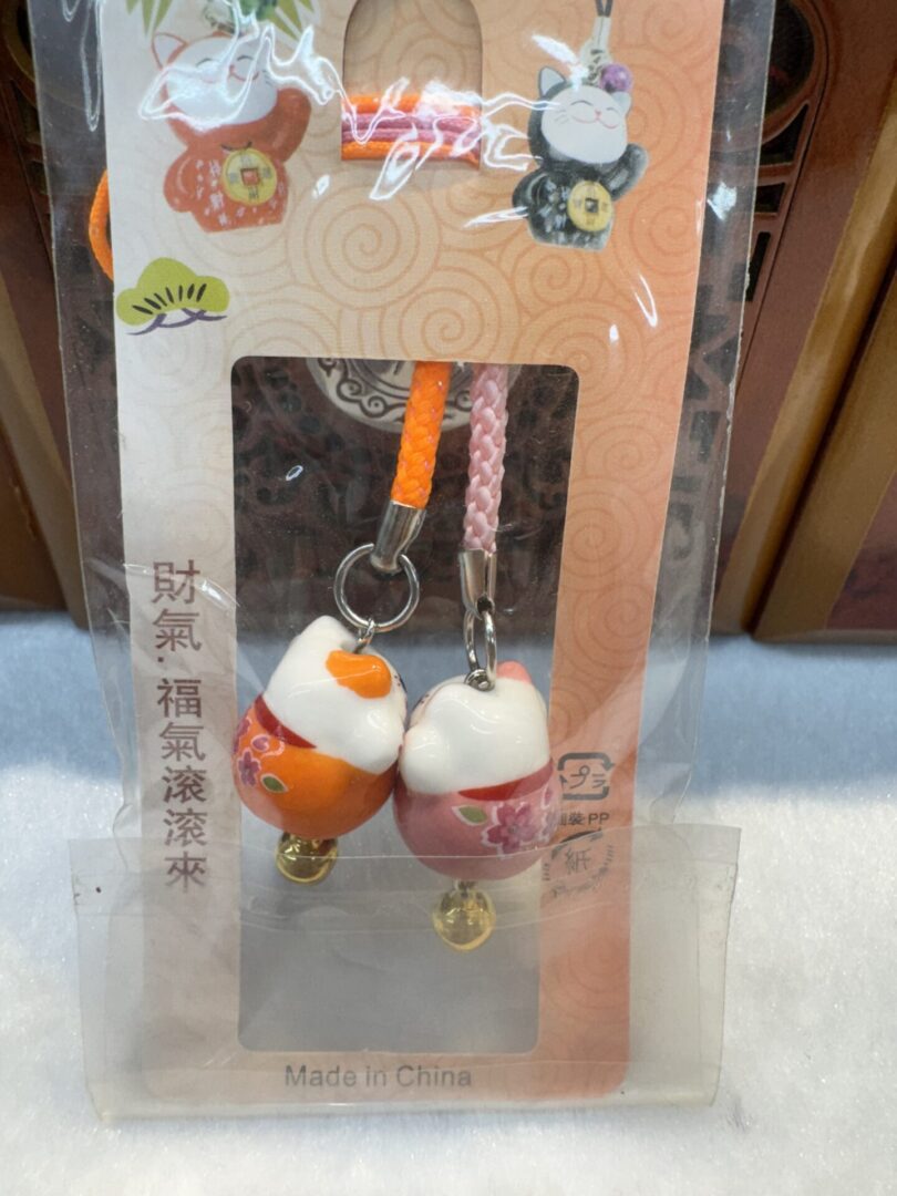 Cat-themed phone charms in packaging.
