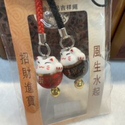 Lucky cat charms with gold bells.