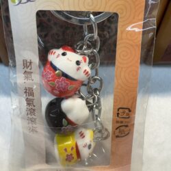 Lucky cat keychains in packaging.