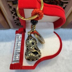 Ornate keychain in red velvet box.