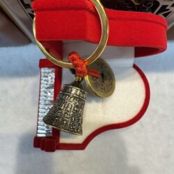 Decorative bell keychain in red velvet box.