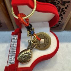 Red keychain with Chinese coin and charm.