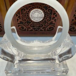 Circular jade disk framed by carved wood