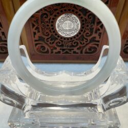 Translucent white jade bangle on acrylic