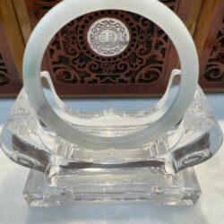 Crystal stand with circular design and carvings.