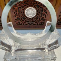 Light gray-green jade ring with dark green fleck