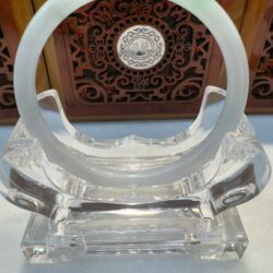 Light green jade ring framed by wood carving