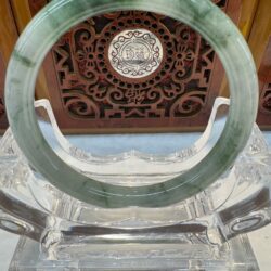 Variegated green jade hoop on acrylic holder