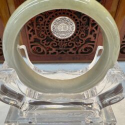 Translucent celadon bangle with carved backdrop