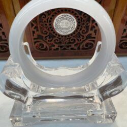 Polished white jade bangle with wood backdrop