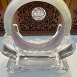 Translucent lavender-grey jade bangle display