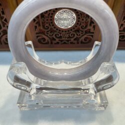 Crystal sculpture with circular ring design.