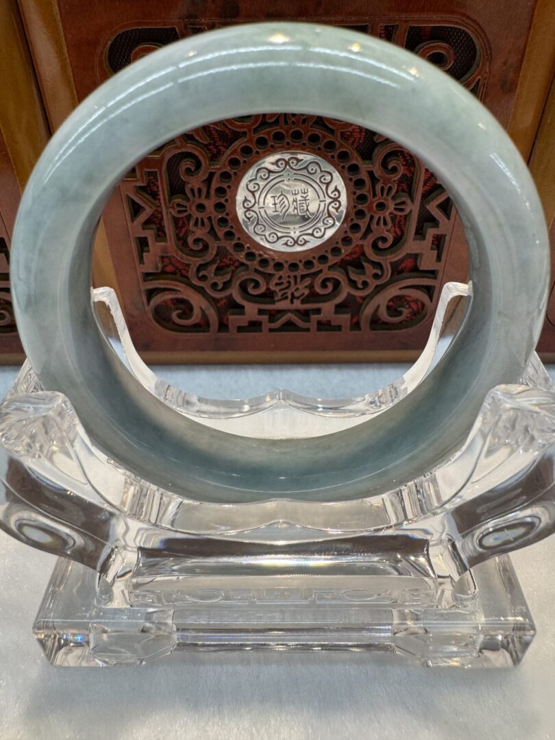Pale green jade bracelet on crystal stand