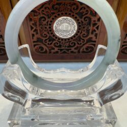 Light blue-green jade bangle with darker spot