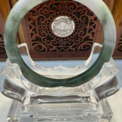 Circular two-tone jade bracelet with carving backdrop