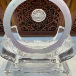 Soft lilac jade circle displayed on acrylic