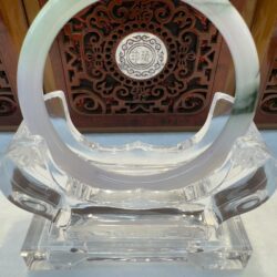 Smooth jade ring resting on acrylic stand