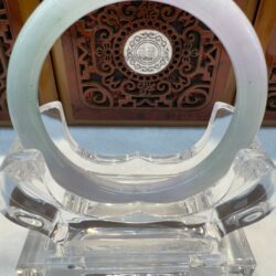 Pale jade circular bangle on clear display