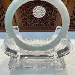 Translucent round jade bracelet on crystal display