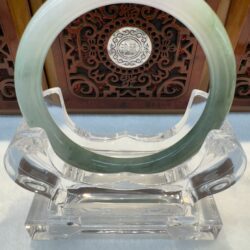 Light lavender-green jade circle on stand