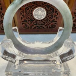 Light green jade circle on lucite holder