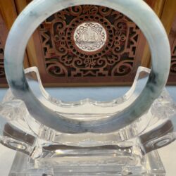 Translucent jade ring with decorative wood backdrop