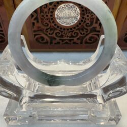 Translucent jade bangle with wooden backdrop