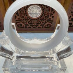 Smooth white jade bracelet on crystal stand