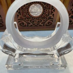 Translucent jade bangle on crystal stand
