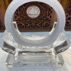 Translucent white jade ring displayed on stand