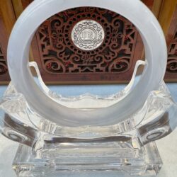 White jade ring on clear crystal pedestal