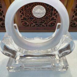 Milky white jade bangle on clear stand