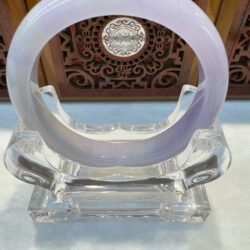 Translucent lilac jade bangle with ornate backdrop