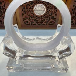 Pale greenish jade bangle on acrylic holder
