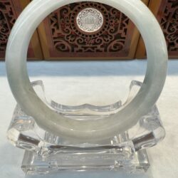Smooth light jade bracelet on clear base