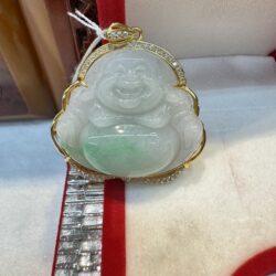 Jade Buddha pendant in red-lined box.