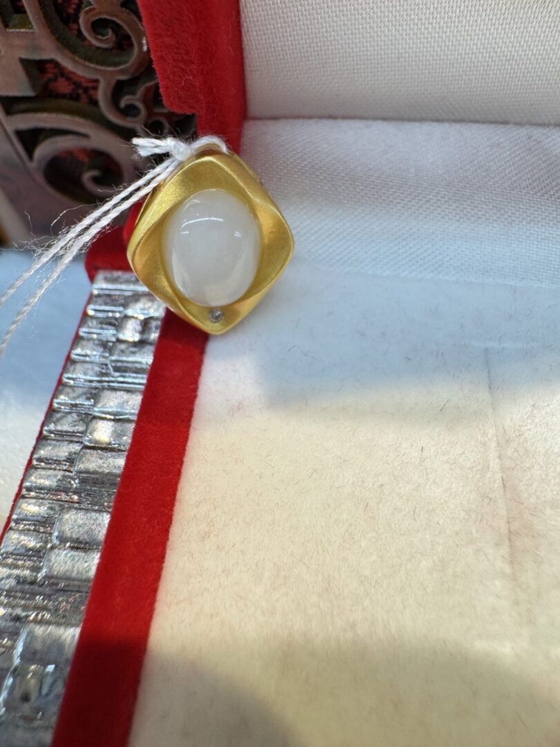 Matte gold lozenge pendant with cabochon